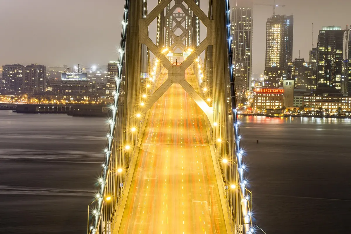 The Bay Bridge at night, lit from end to end