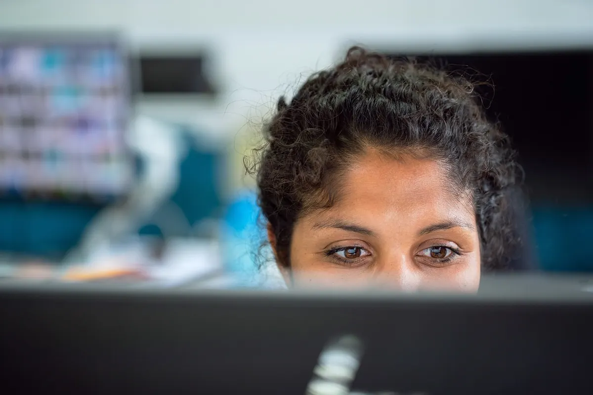 An HR professional reviewing data at her workstation